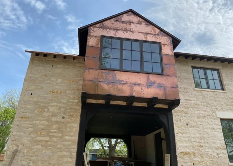 Copper metal panel facade on a stone building for Skylight Installation in Bellflower