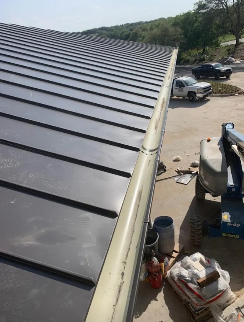Standing seam panel and gutter detail on a metal roofing jobsite in Bellflower